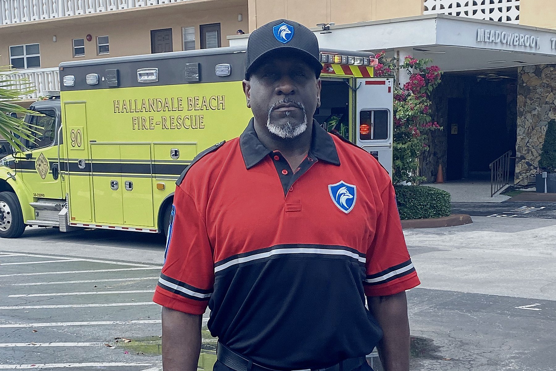 Foxtrot officer with a fire extinguisher in front of a Hallandale Beach Fire-Rescue unit